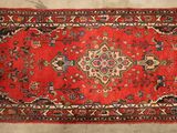 a red rug with a floral design on it