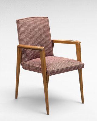 a close up of a chair with a pink upholstered seat