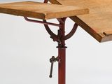 a wooden table with a metal base and a wooden table top