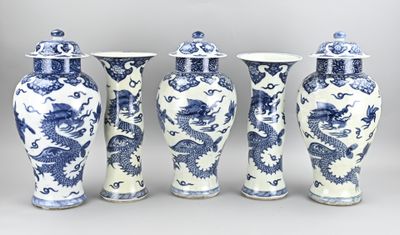 four blue and white vases with dragon designs on them