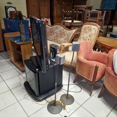 a television that is sitting on a stand in the middle of a room