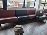 a couch that is sitting in a room with a lot of windows
