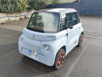 a small car that is parked in a parking lot