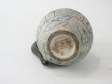 a white and blue vase with writing on it on a table