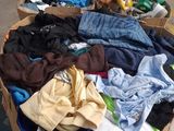 a basket full of clothes sitting on the floor