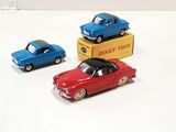 three toy cars sitting next to each other on a table