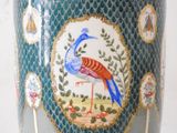 a vase with a bird painted on the side of it