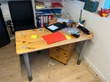 a desk with a chair and a computer on it