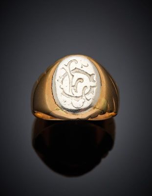 an image of a gold ring with a roman coin in the center