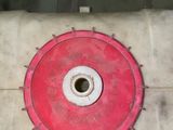 a red wheel on the side of a white pipe