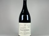 a bottle of wine sitting on top of a white table