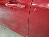 a close up of a red car door handle