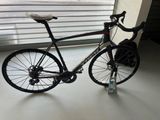 a bike that is sitting on the floor by the window