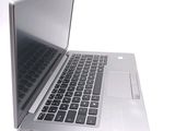 a silver laptop computer sitting on top of a white table