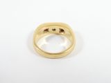 an 18k yellow gold ring set with a single diamond