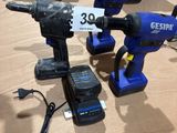 three electric tools sitting on a table with a price tag