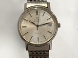a silver watch that is sitting on a table