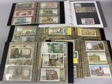 a lot of different types of paper money on the table