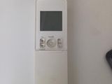 a remote control sitting on a table next to a speaker