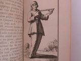 an old book with a picture of a man holding a gun