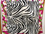 a chair with a zebra print blanket on it