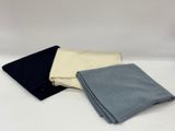 three different colors of cloth folded on top of each other