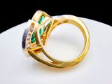 an image of a gold ring with emeralds and diamonds