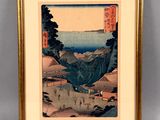 an image of a framed picture of a landscape with mountains and a body of water