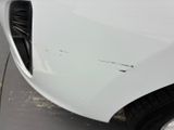 a close up of a car ' s front bumper with scratches