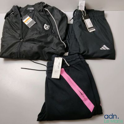two pairs of black and pink tracksuits with tags on them
