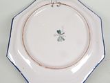 a close up of a plate with a flower on it