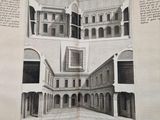 an open book with a drawing of a building and a picture of a courtyard
