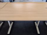 a wooden table with four legs and a white base