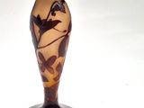a lamp that has a bird on it on a table