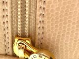 a close up of a purse that has a gold lock on it