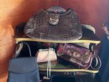 several purses are stacked on top of each other on a table