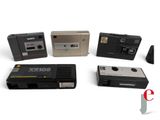 four different types of cassette recorders on a white surface