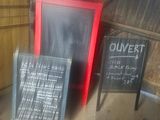 a chalk board with a menu on it next to a chalk board