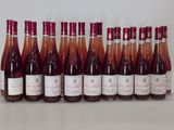 many bottles of wine lined up on a table