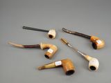 several different types of pipes are lined up on a gray surface