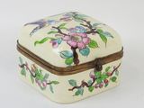 a small white box with a floral design on it