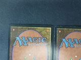 two decks of magic the gathering cards are on a table