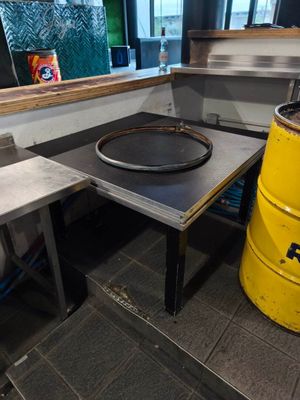 a yellow barrel sitting next to a table in a kitchen