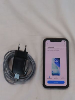 a cell phone that is sitting next to a charger