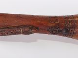 a wooden baseball bat with a wooden handle on a white surface