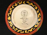 a bowl with a design on it on a black surface