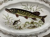 a plate with a fish on it on a table