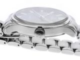 a close up of a watch with a chain around it