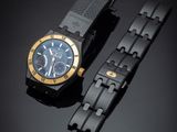 the watch is black and gold with a blue dial
