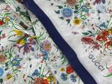 a close up of a pair of white and blue floral print scarves